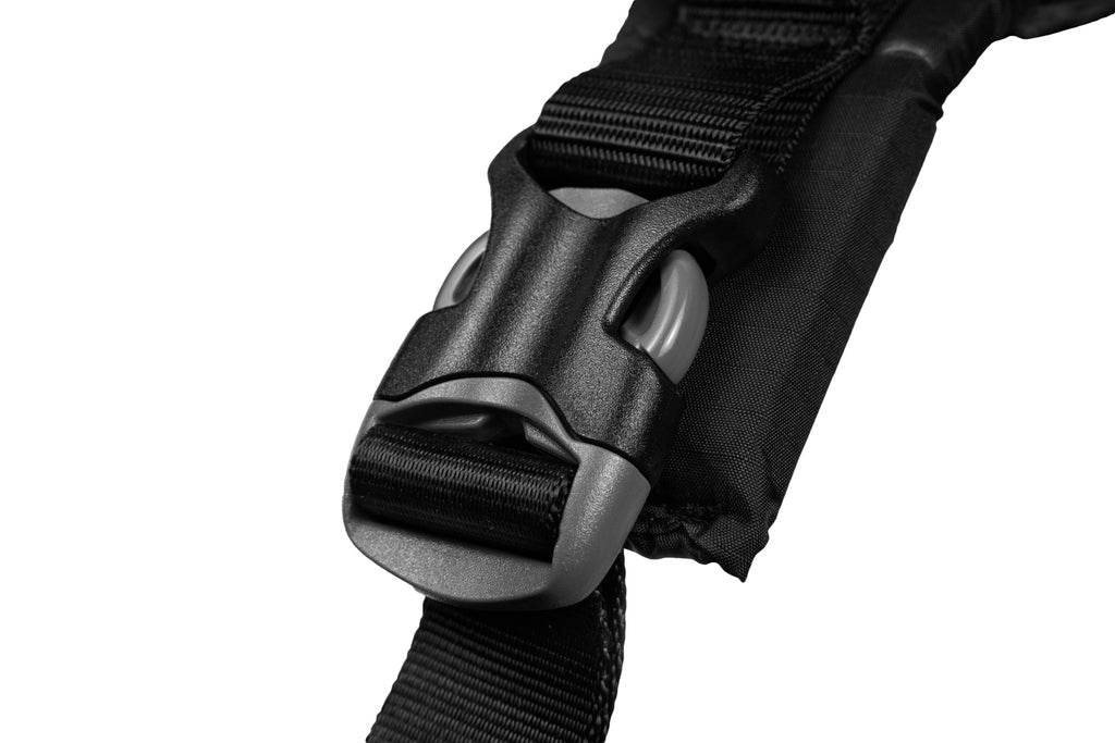 Close-up of a black strap with a buckle on a white background