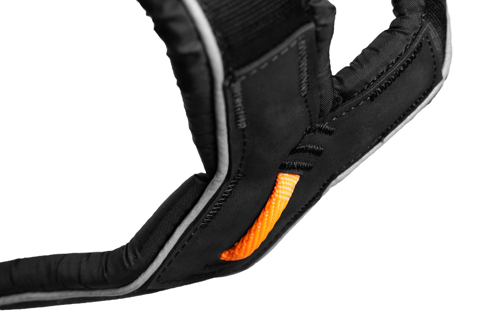 Close-up of a black and orange dog harness on a white background